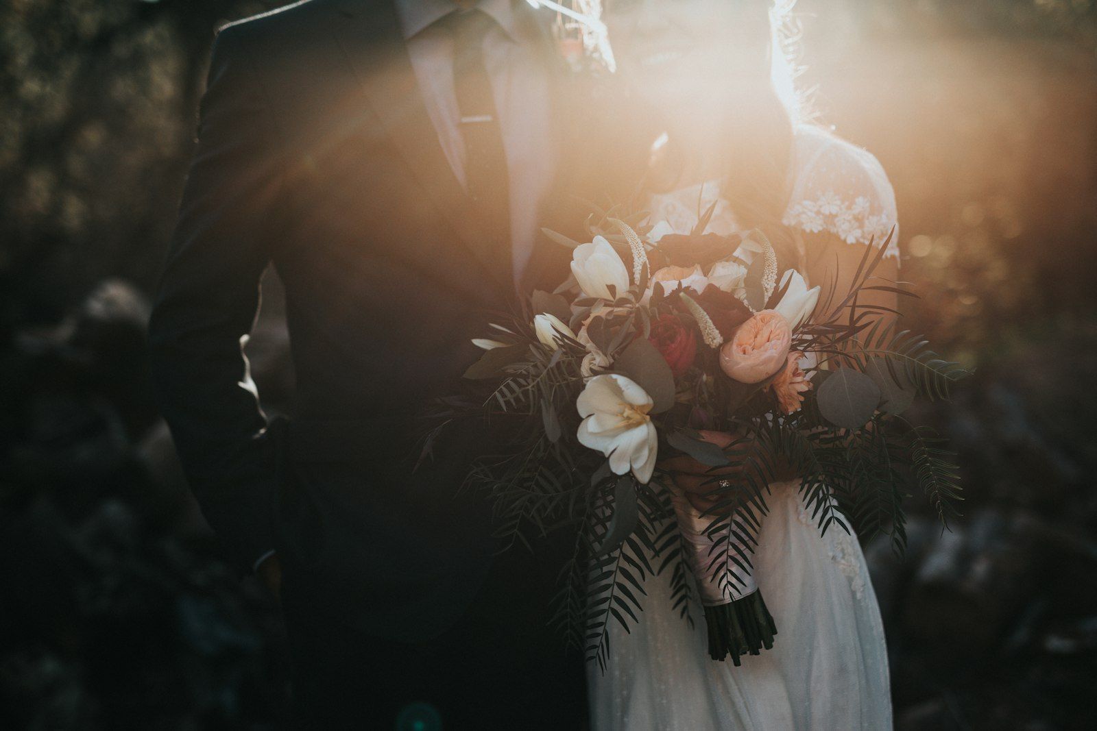 A bride holding a bouquet in warm evening light