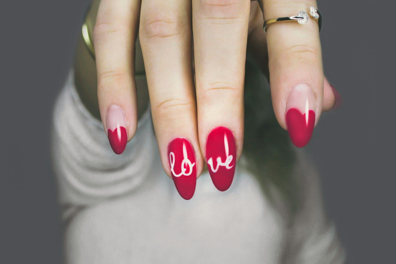 Almond nails painted rose with hand-lettered detail