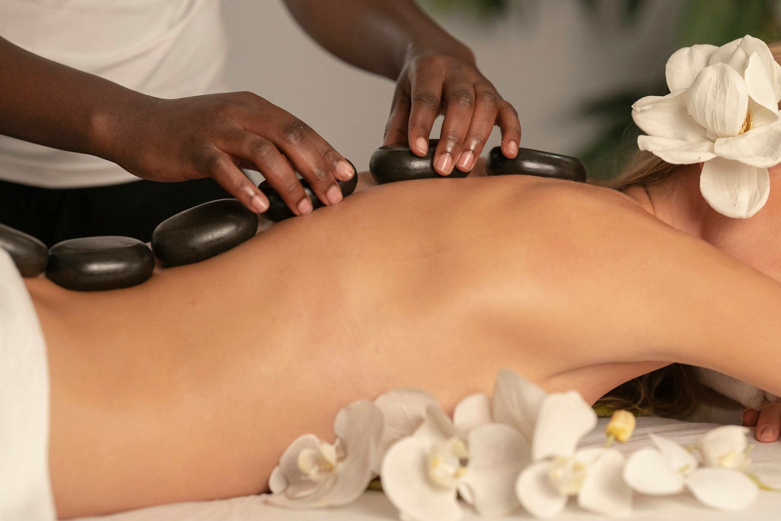 Hot stone massage with white orchids
